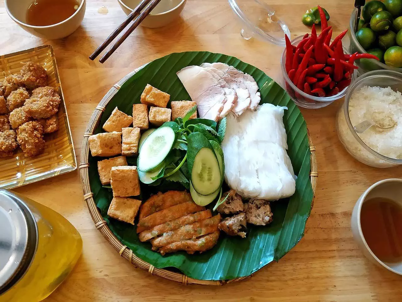 Ein Teller mit asiatischen Fleischgerichten auf einem Holztisch.