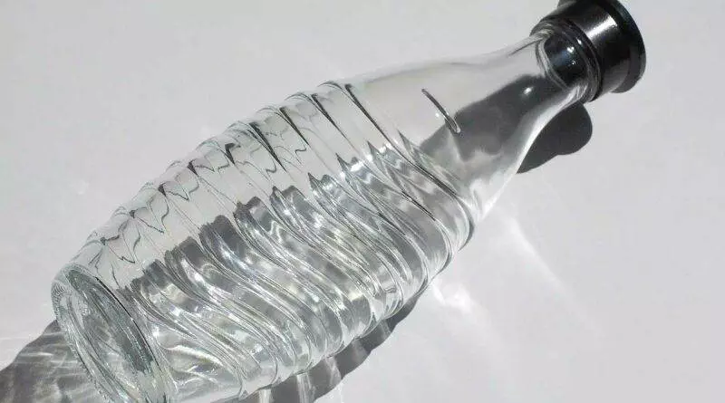 Eine Sodastream-Flasche mit schwarzem Deckel auf einer weißen Oberfläche.