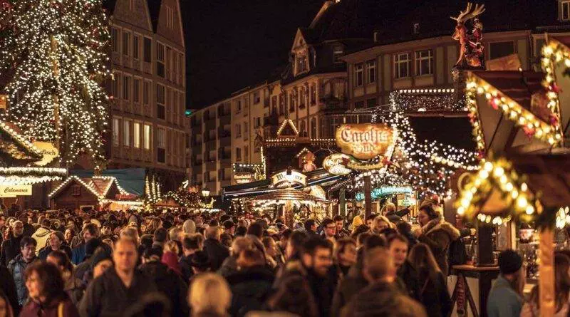 Ein überfüllter Weihnachtsmarkt in einer Stadt.