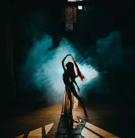 Silhouette einer Tänzerin in einem dunklen Raum.